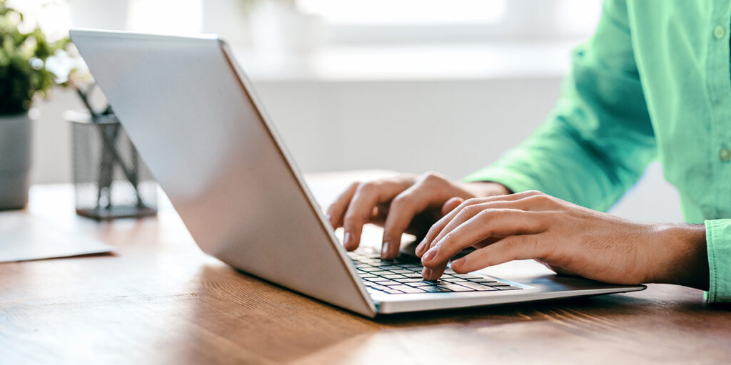 Man typing on laptop